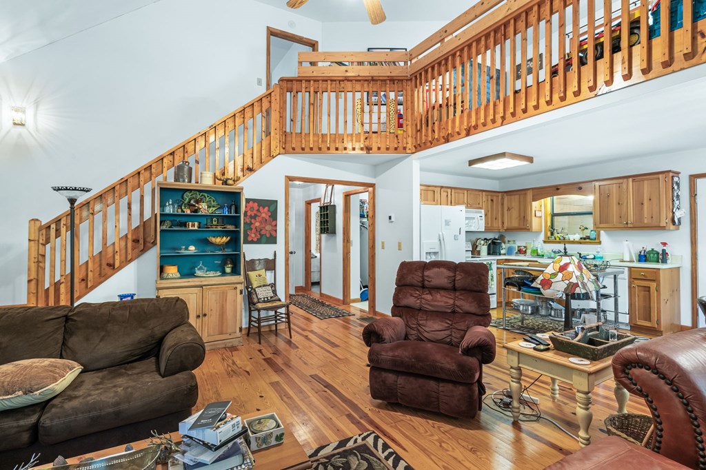 1628 Woods Valley Road Young Harris, GA 30582 - Photo 8 of 36 a living room with furniture a ceiling fan and a window