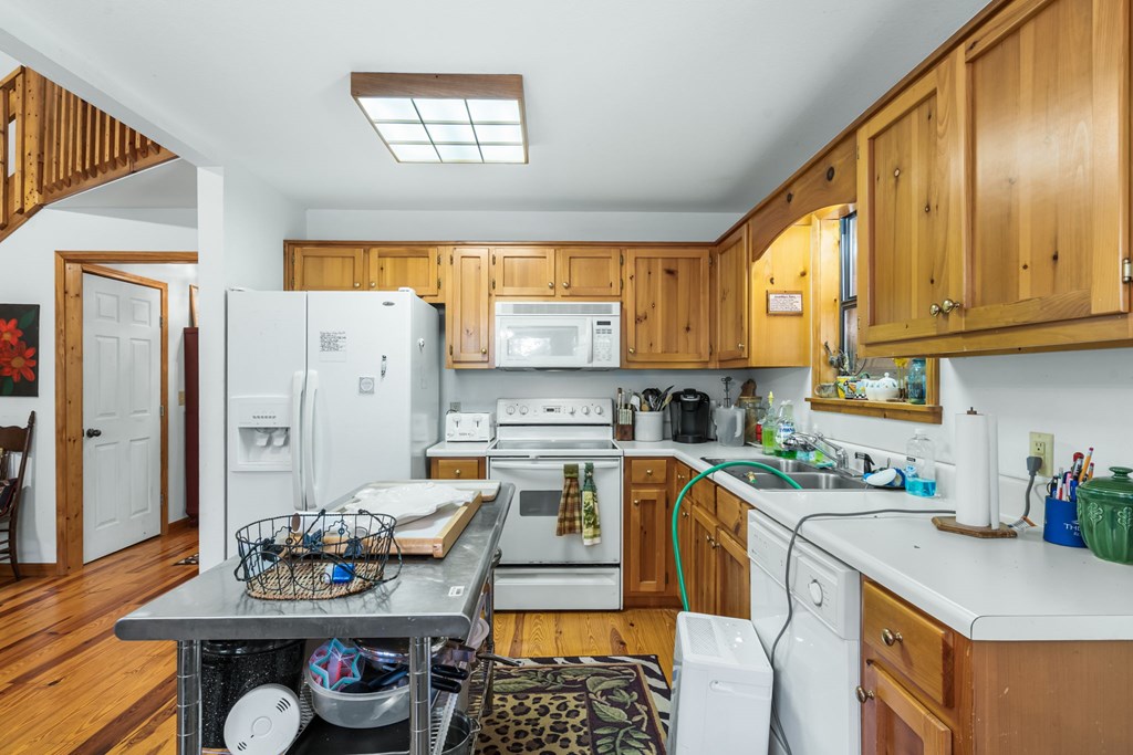 1628 Woods Valley Road Young Harris, GA 30582 - Photo 10 of 36 a kitchen with stainless steel appliances granite countertop a stove a sink and a refrigerator