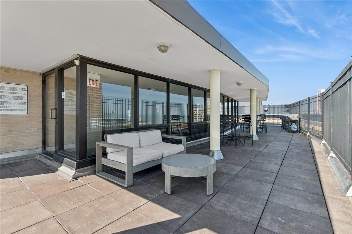 2930 North Sheridan Road, Unit 1403 Chicago, IL 60657 - Photo 15 of 19 a living room with furniture and a floor to ceiling window