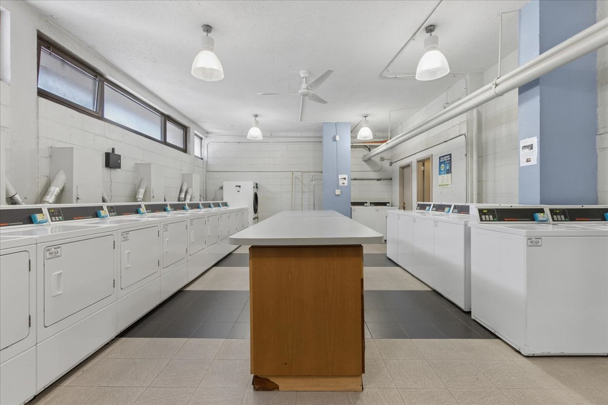 2930 North Sheridan Road, Unit 1403 Chicago, IL 60657 - Photo 16 of 19 a large white kitchen with lots of counter space and cabinets