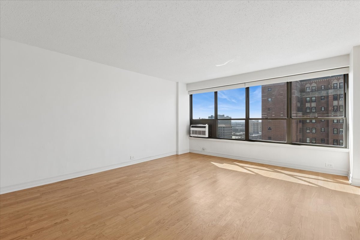 2930 North Sheridan Road, Unit 1403 Chicago, IL 60657 - Photo 3 of 19 a view of an empty room with a window
