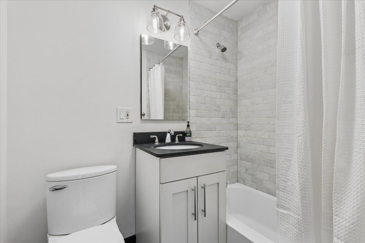 2930 North Sheridan Road, Unit 1403 Chicago, IL 60657 - Photo 10 of 19 a bathroom with a sink a toilet and shower