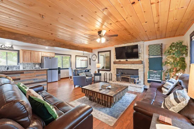 a living room with fireplace furniture and a flat screen tv