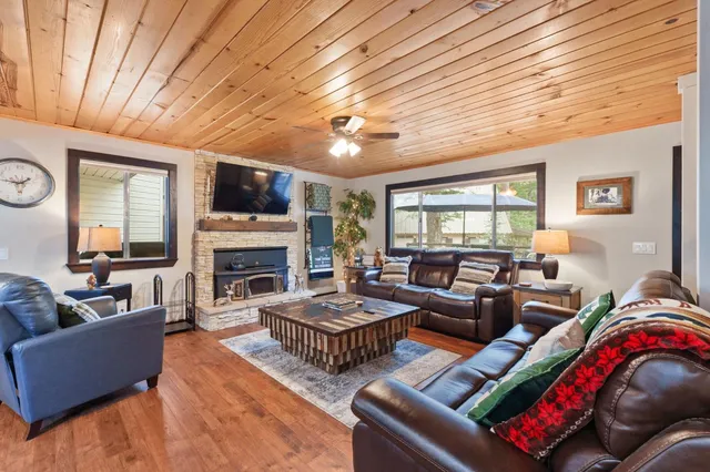 a living room with furniture a fireplace and a flat screen tv