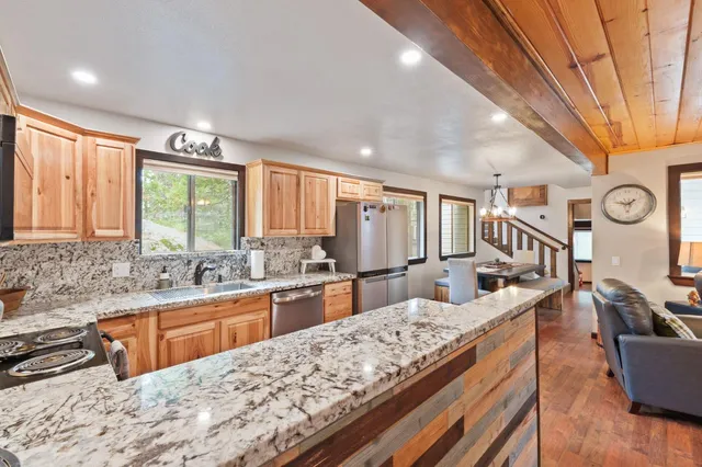 a large kitchen with granite countertop a large window and a counter space