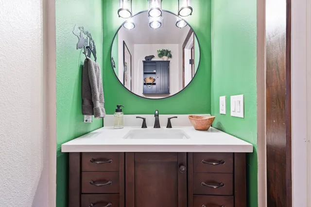 a bathroom with a sink and a mirror