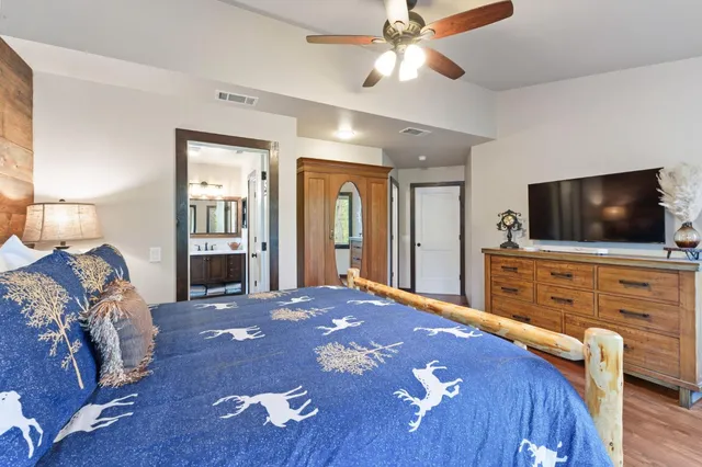 a bedroom with a bed and a flat screen tv