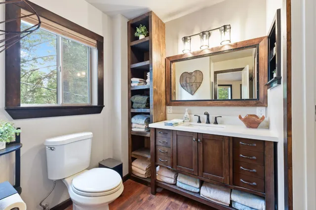 a bathroom with a toilet a sink and mirror