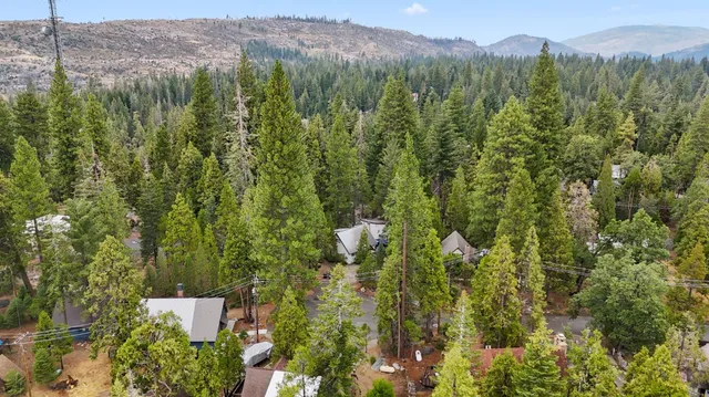 an aerial view of a house with a yard and garden