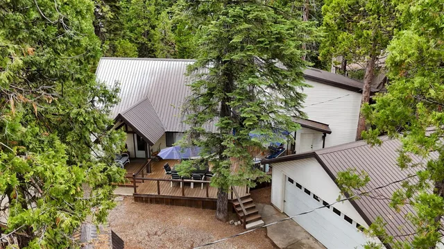 front view of a house with a tree