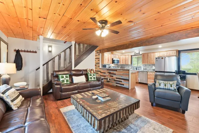 a living room with furniture and wooden floor