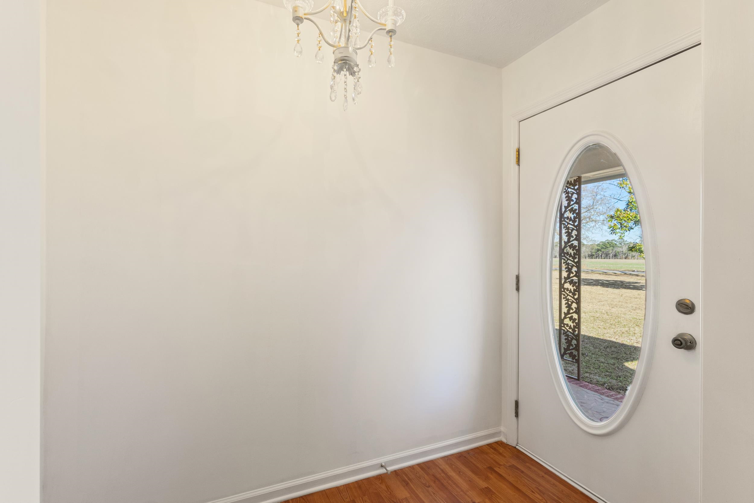 3923 State Rd S-26-33 Green Sea, SC 29545 - Photo 11 of 40 Entryway with wood finished floors and a chandelier