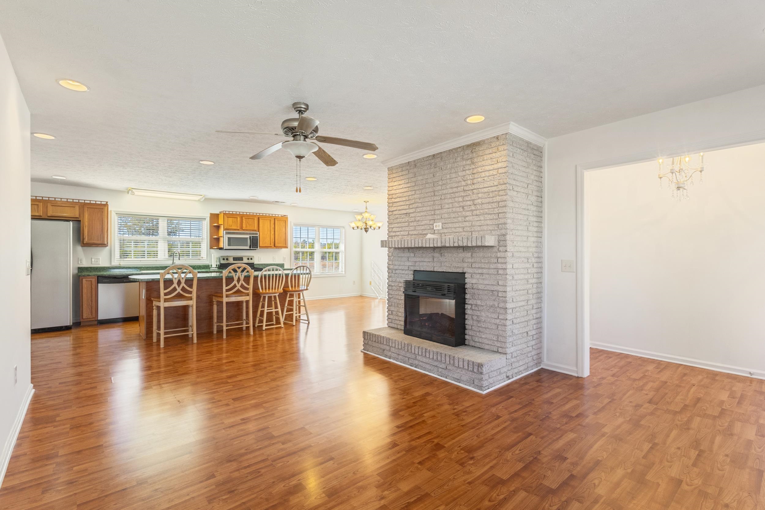 3923 State Rd S-26-33 Green Sea, SC 29545 - Photo 13 of 40 Living room featuring a chandelier, a fireplace, recessed lighting, light wood-style floors, and a ceiling fan