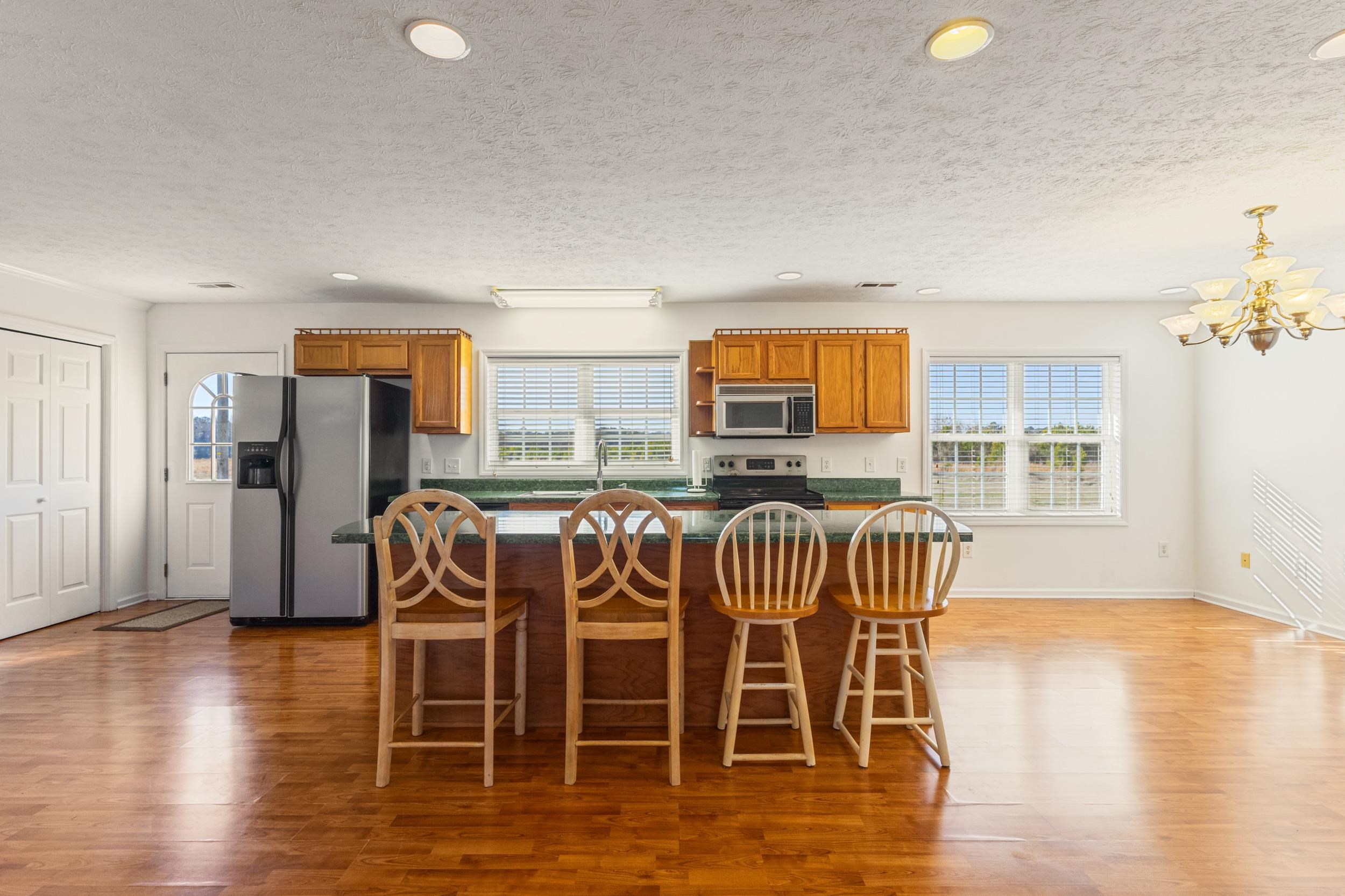 3923 State Rd S-26-33 Green Sea, SC 29545 - Photo 17 of 40 Kitchen with brown cabinets, appliances with stainless steel finishes, recessed lighting, a breakfast bar, and hanging light fixtures