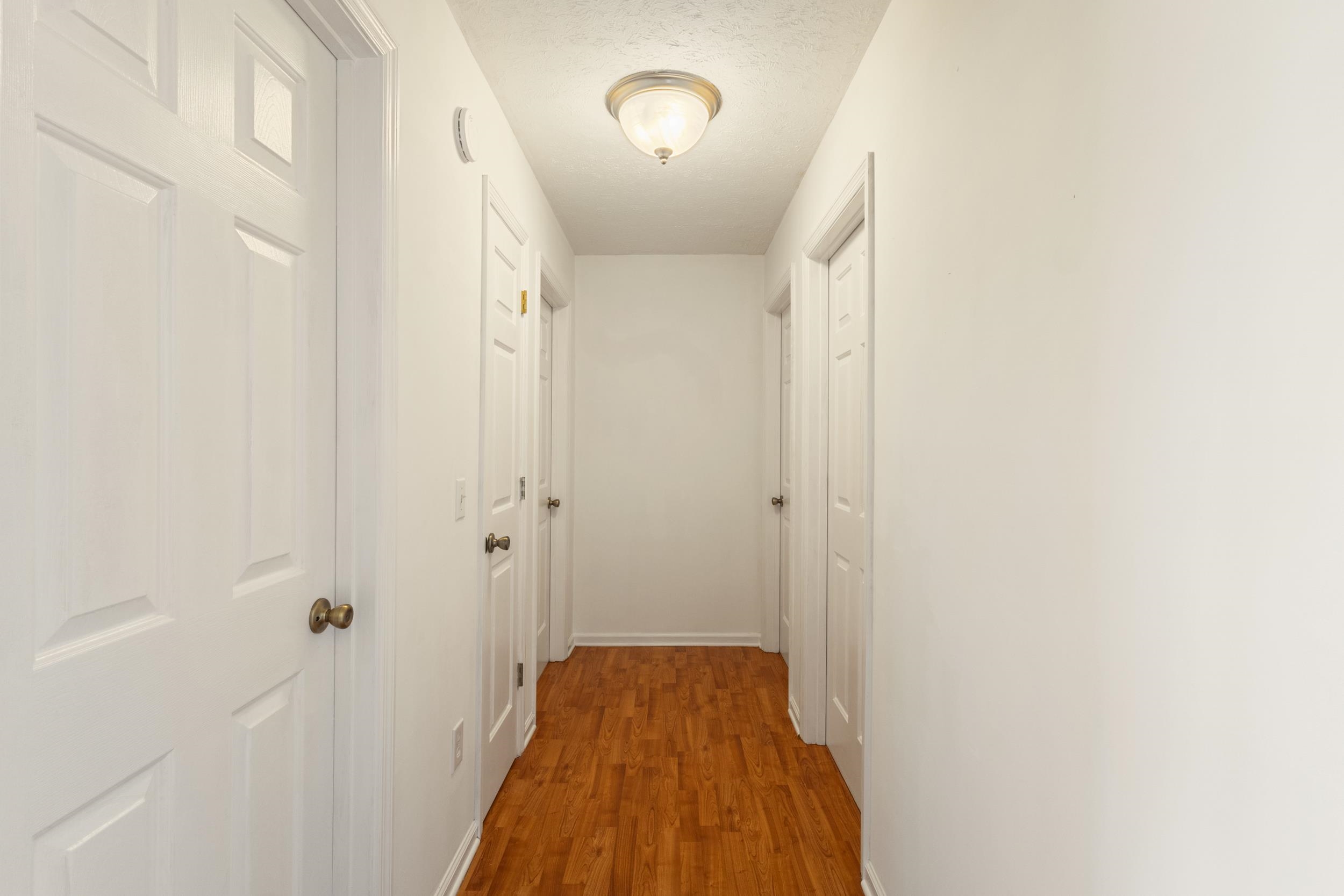3923 State Rd S-26-33 Green Sea, SC 29545 - Photo 27 of 40 Hall featuring wood finished floors and a textured ceiling