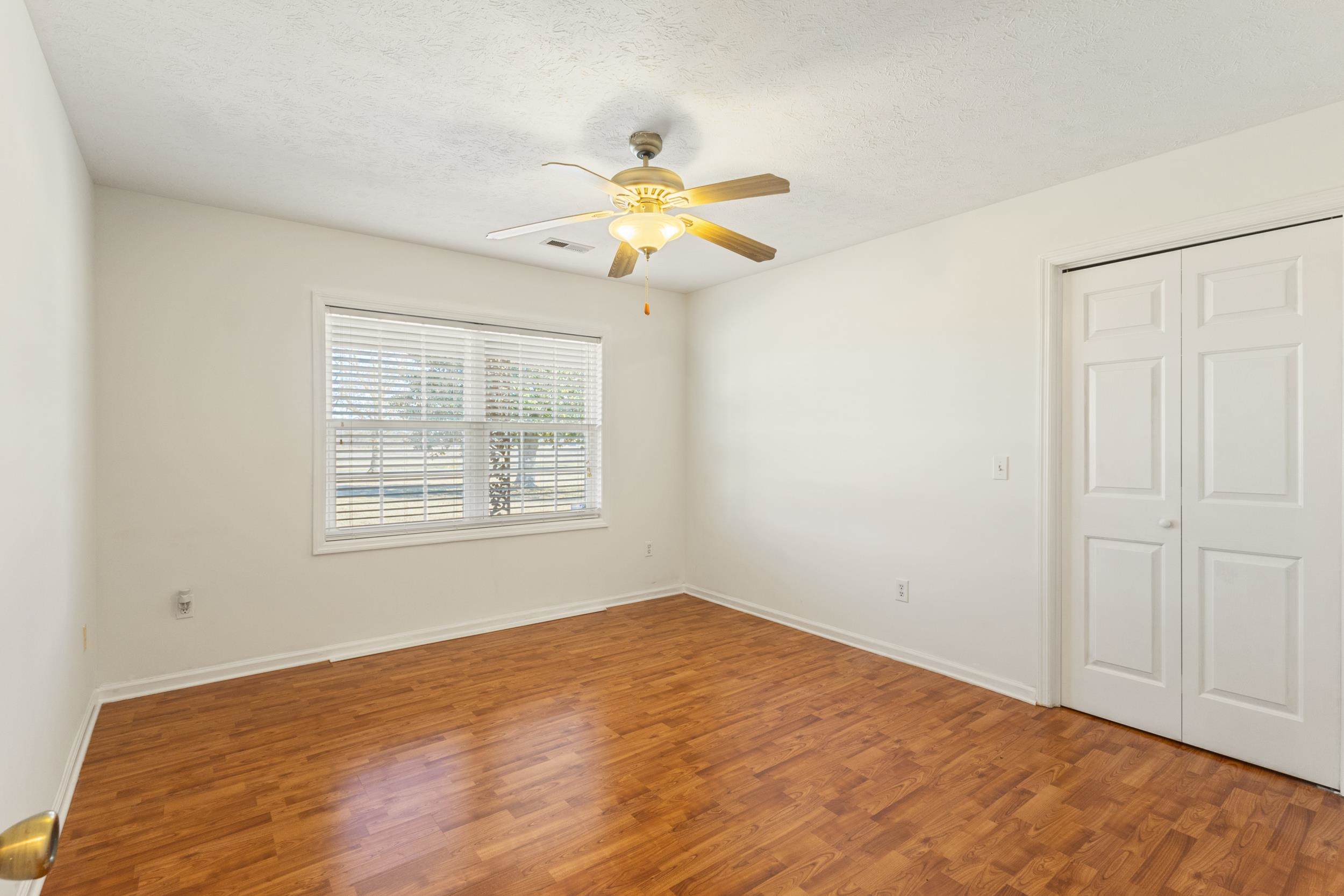3923 State Rd S-26-33 Green Sea, SC 29545 - Photo 30 of 40 Unfurnished bedroom featuring wood finished floors, a textured ceiling, a ceiling fan, and a closet
