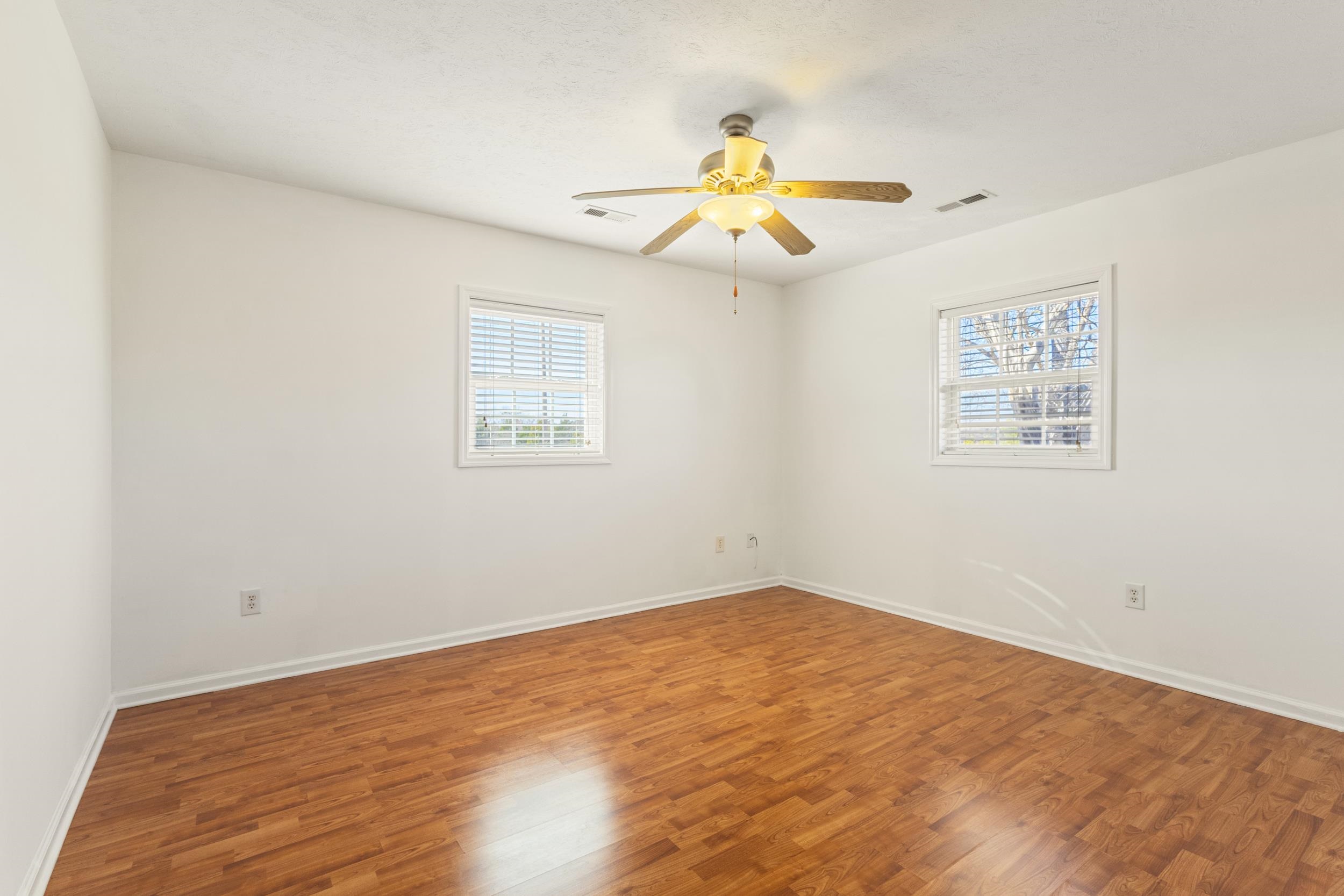3923 State Rd S-26-33 Green Sea, SC 29545 - Photo 33 of 40 Empty room with wood finished floors and ceiling fan