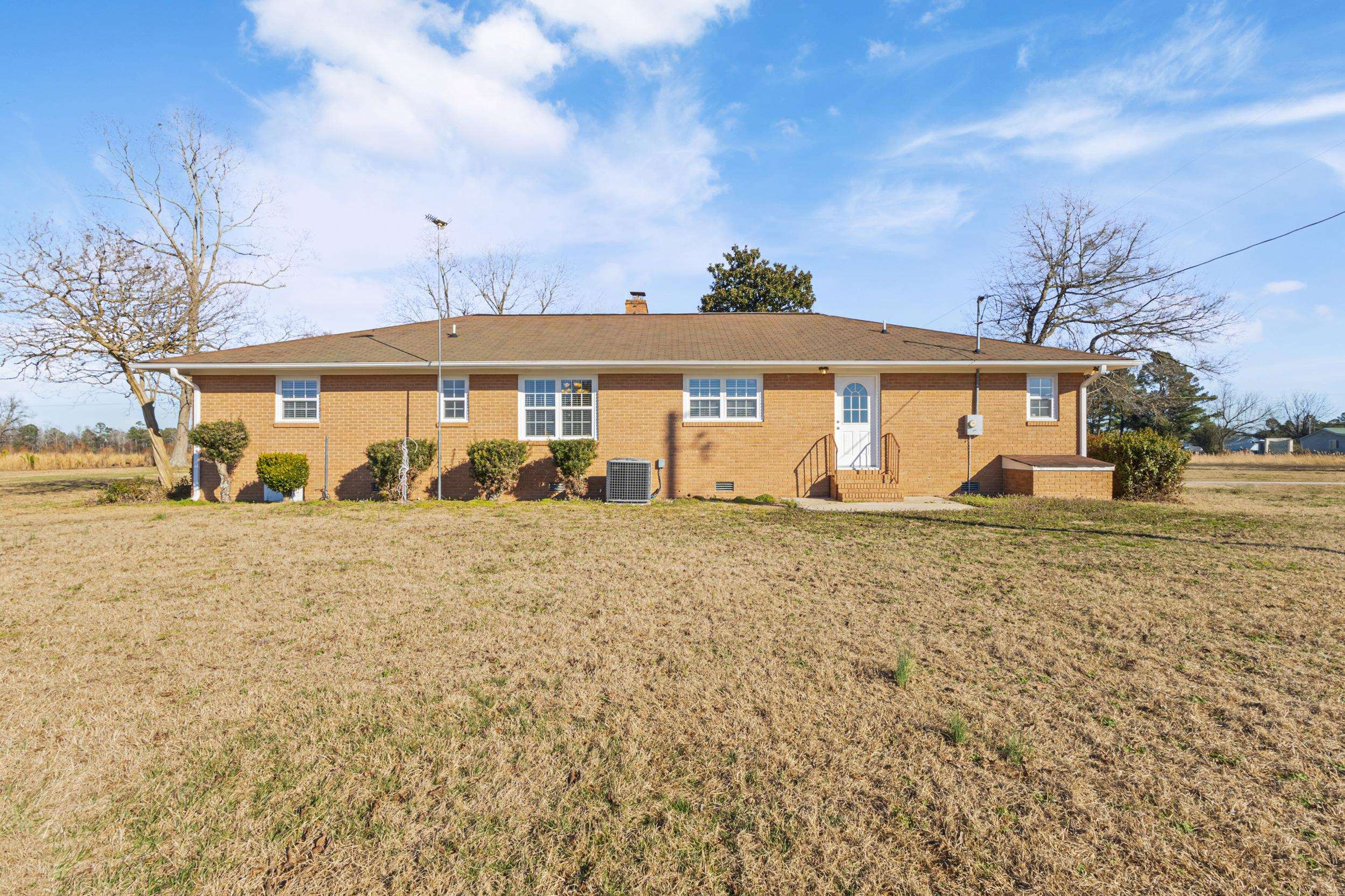 3923 State Rd S-26-33 Green Sea, SC 29545 - Photo 35 of 40 Rear view of house with a lawn, brick siding, a chimney, and crawl space