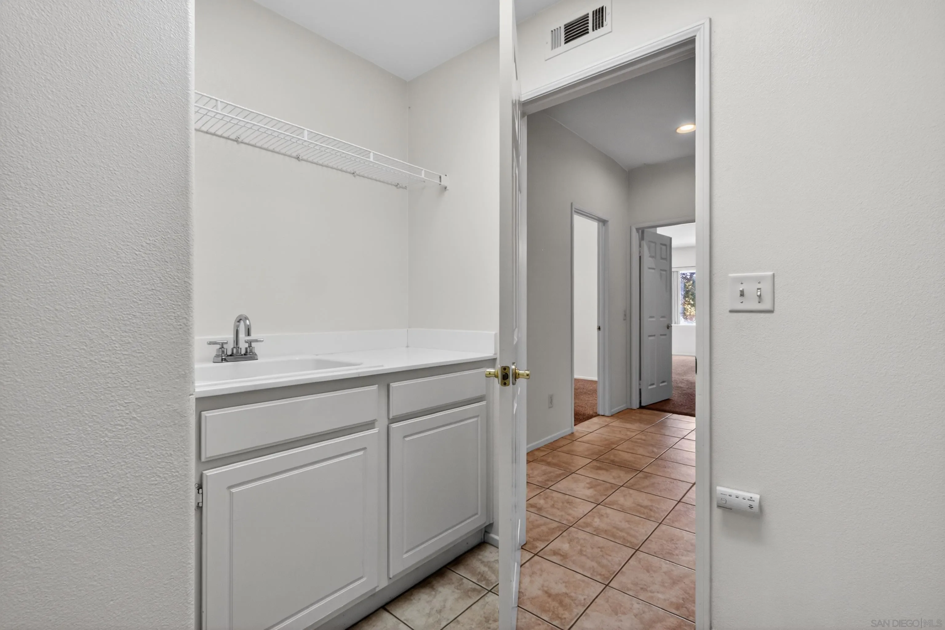 1432 Belmont Park Road Oceanside, CA 92057 - Photo 33 of 54 a bathroom with a sink and a mirror