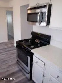 a kitchen with a stove and a microwave