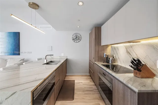 a bedroom with a bed a mirror and lamp