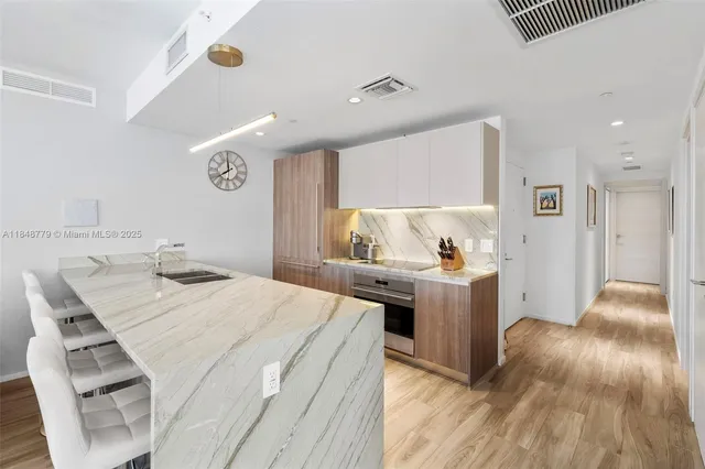 a living room with furniture and large windows