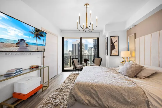 a bedroom with a large bed and a large window