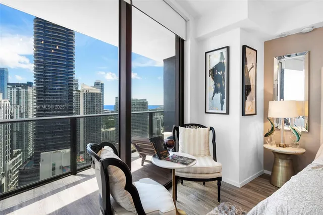 a bedroom with a bed and glass windows