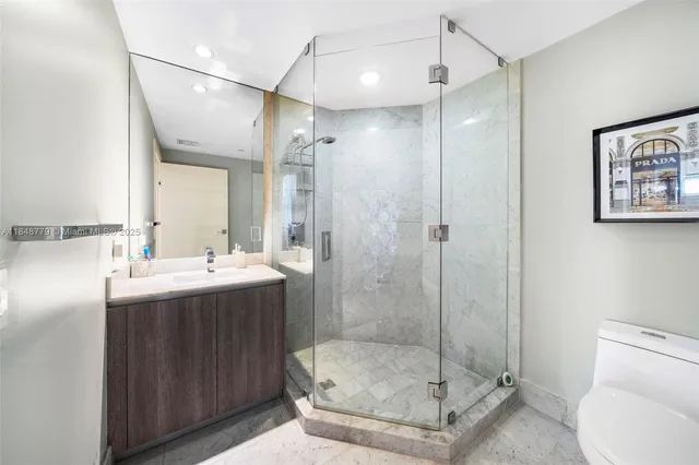 a view of a hallway with wooden floor and closet area