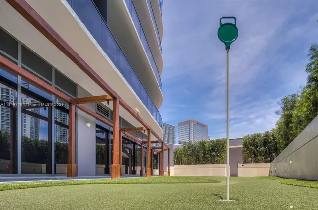 a dining room with furniture and a potted plant