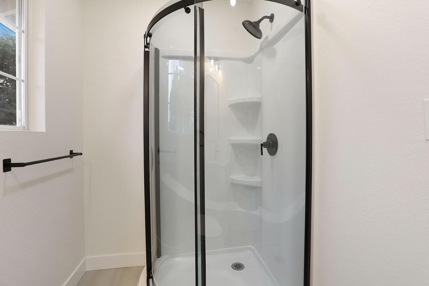 834 North Filbert Street Stockton, CA 95205 - Photo 17 of 22 a bathroom with a glass shower door