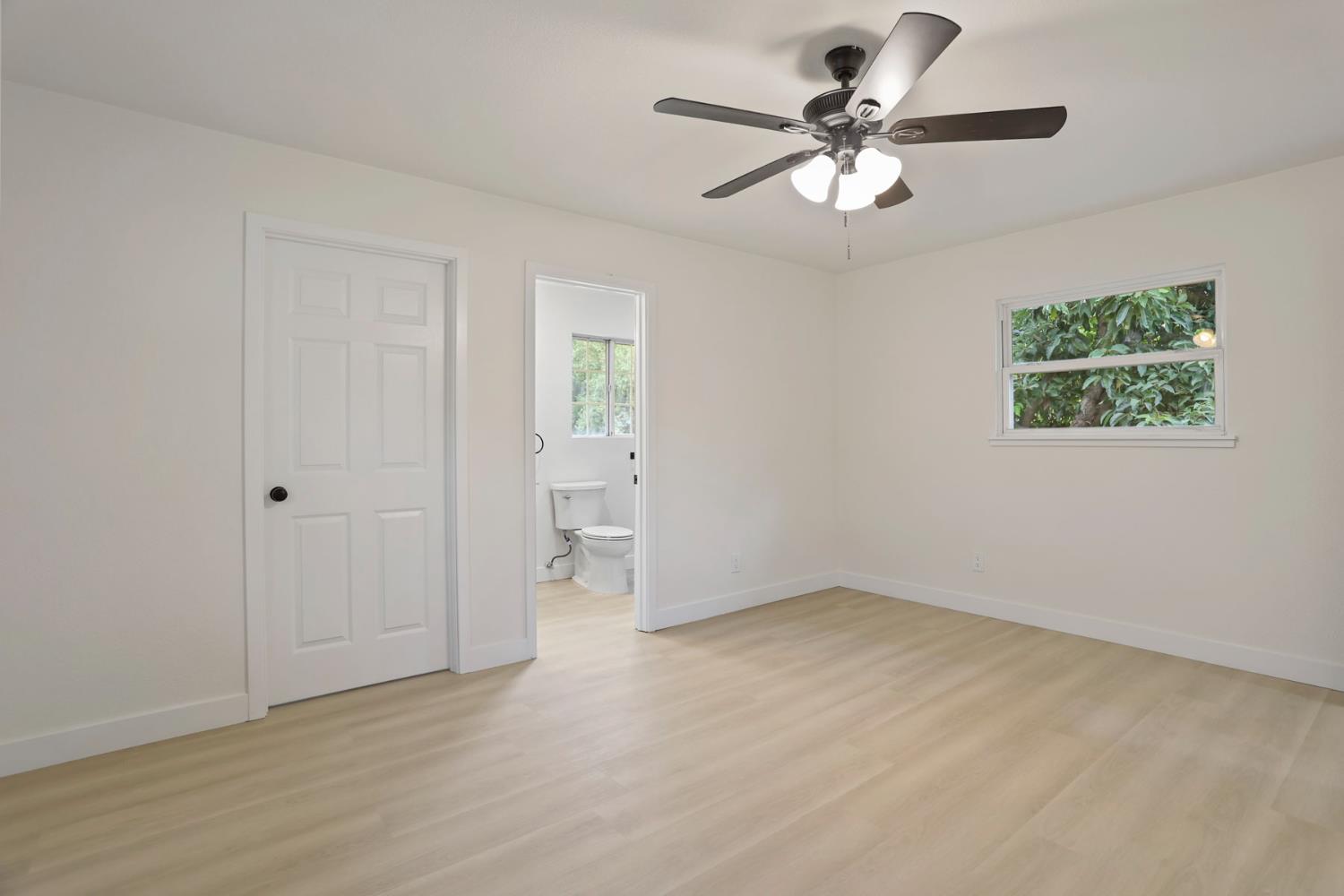 834 North Filbert Street Stockton, CA 95205 - Photo 18 of 22 wooden floor in an empty room with a window