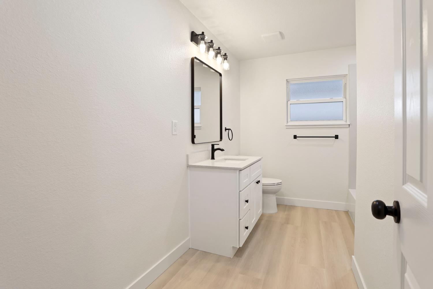834 North Filbert Street Stockton, CA 95205 - Photo 19 of 22 a bathroom with a sink and mirror