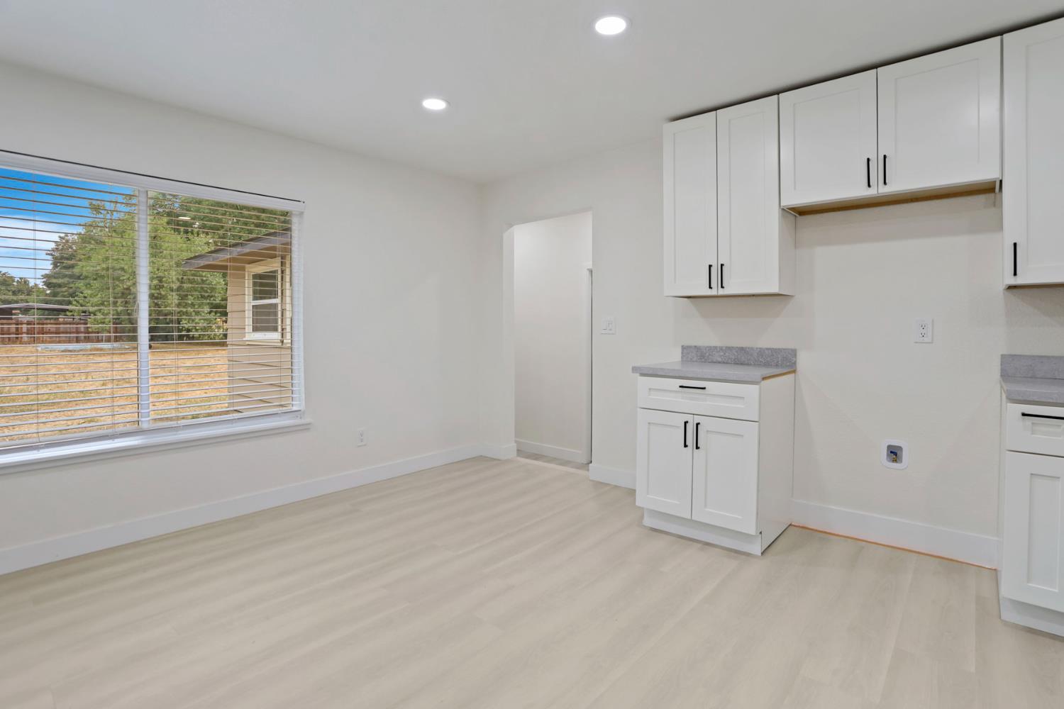 834 North Filbert Street Stockton, CA 95205 - Photo 6 of 22 a kitchen with white cabinets and a window