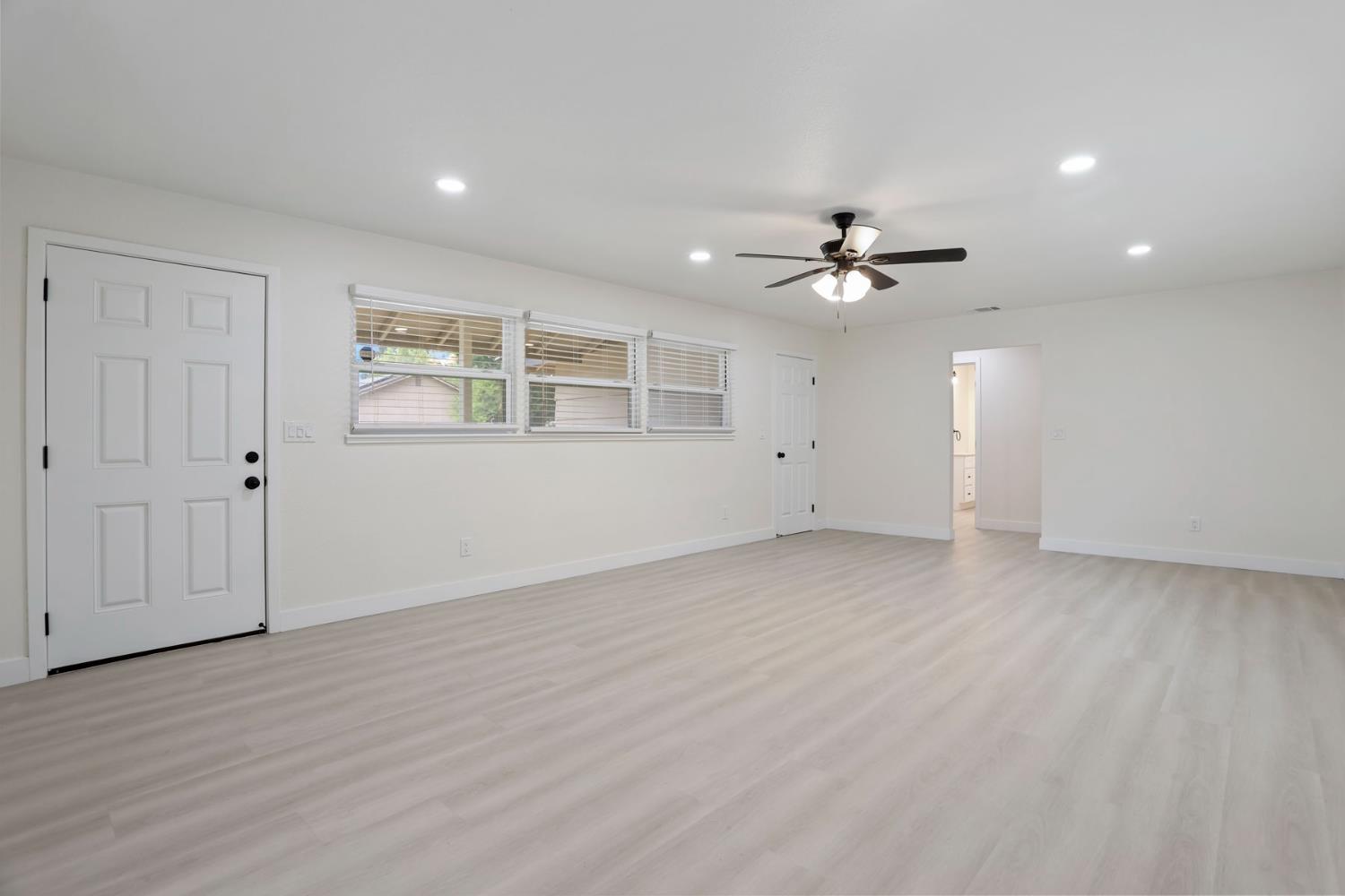 834 North Filbert Street Stockton, CA 95205 - Photo 8 of 22 an empty room with wooden floor and ceiling fan
