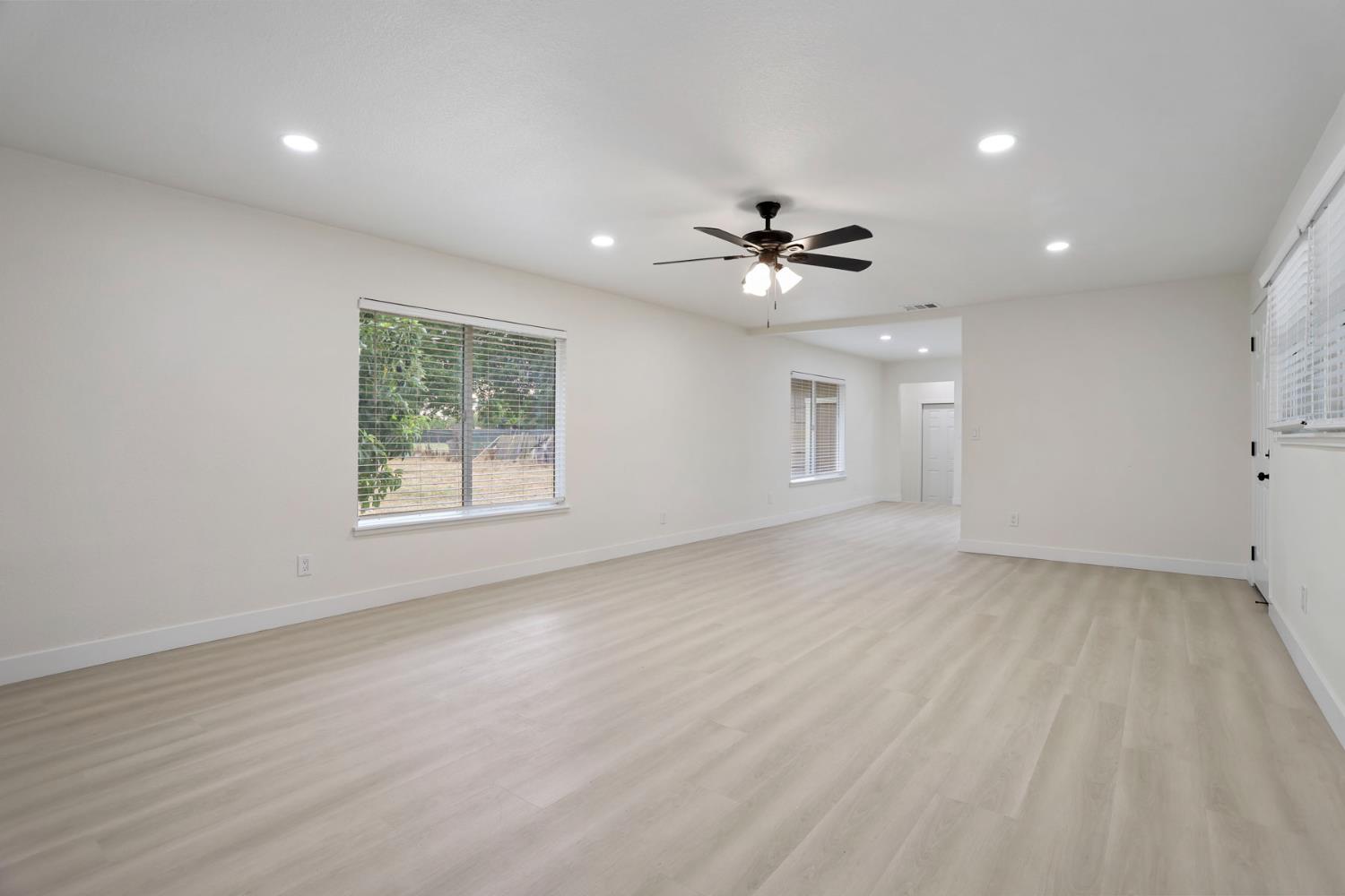 834 North Filbert Street Stockton, CA 95205 - Photo 9 of 22 an empty room with windows and ceiling fan