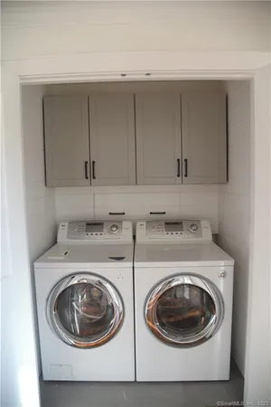 a utility room with sink dryer and washer