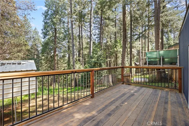 a view of a balcony with wooden floor and fence