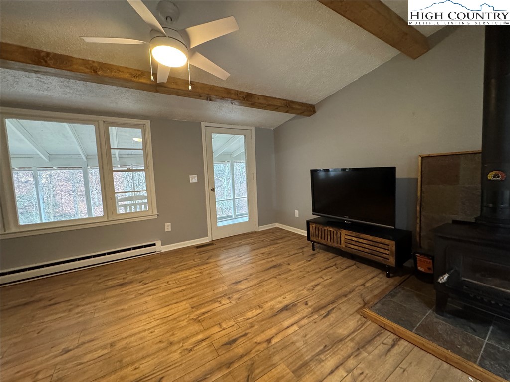 321 Skin Camp Creek Road Todd, NC 28684 - Photo 3 of 29 a living room with a flat screen tv and a fireplace