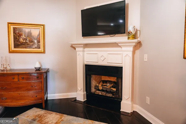 a living room with a fireplace and a flat screen tv
