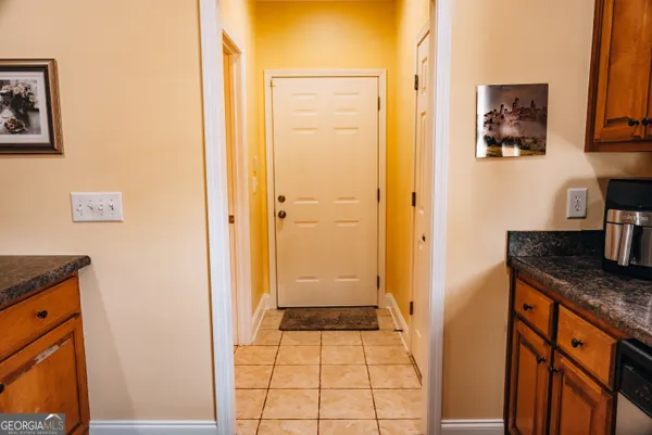 a bathroom with a granite countertop sink a toilet and a shower