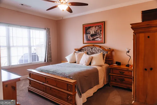 a bedroom with bed and a window