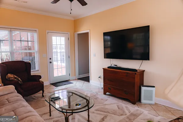 a living room with furniture and a flat screen tv
