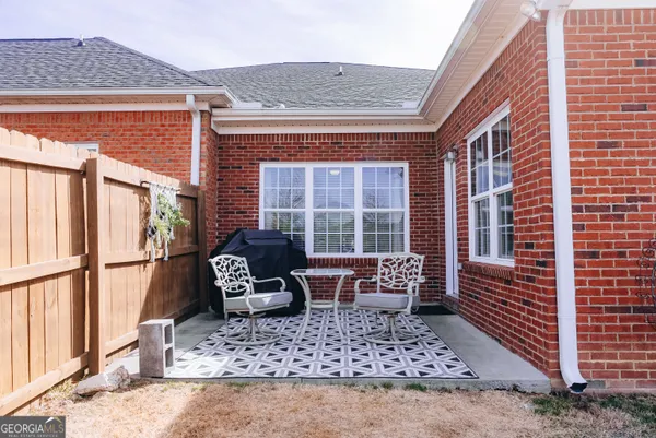 a balcony with furniture and wooden floor