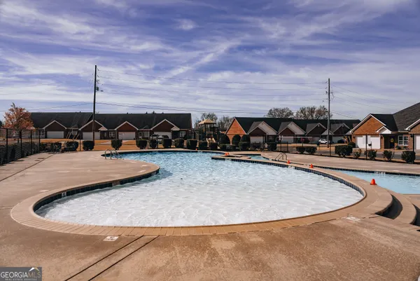 a view of swimming pool with outdoor seating