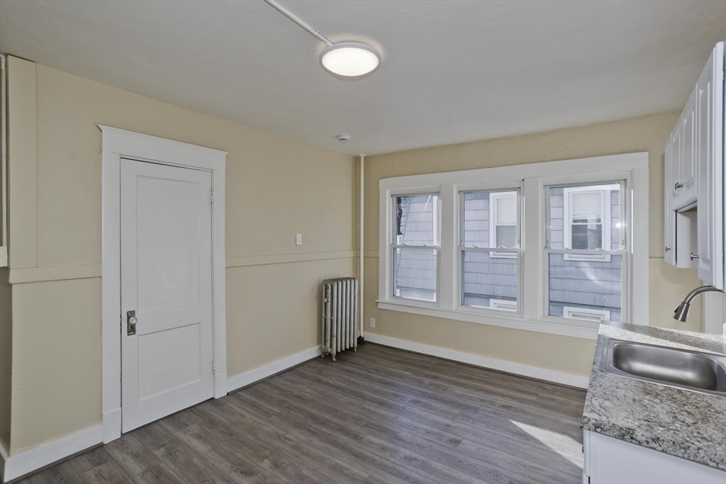 1200 Grattan Street, Unit 2L Chicopee, MA 01013 - Photo 3 of 10 an empty room with wooden floor and windows