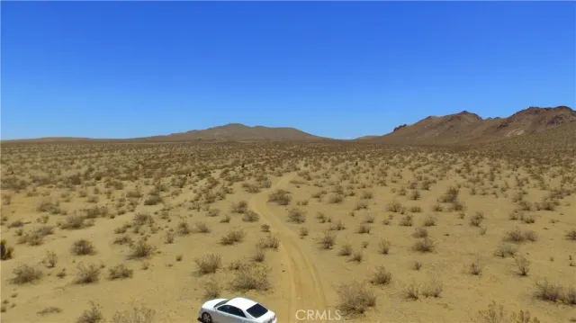 a view of a large mountain with mountains in the background