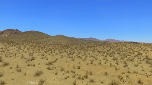 a view of a large mountain with mountains in the background
