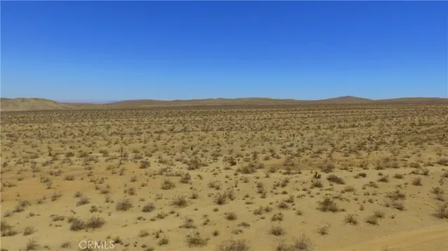 a view of a large mountain with mountains in the background