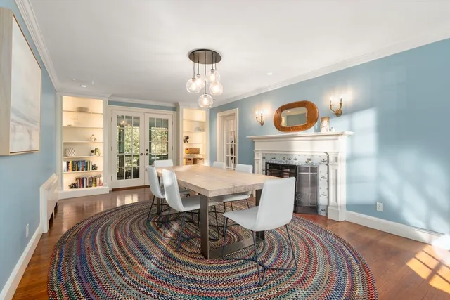 a living room with furniture a fireplace and a table